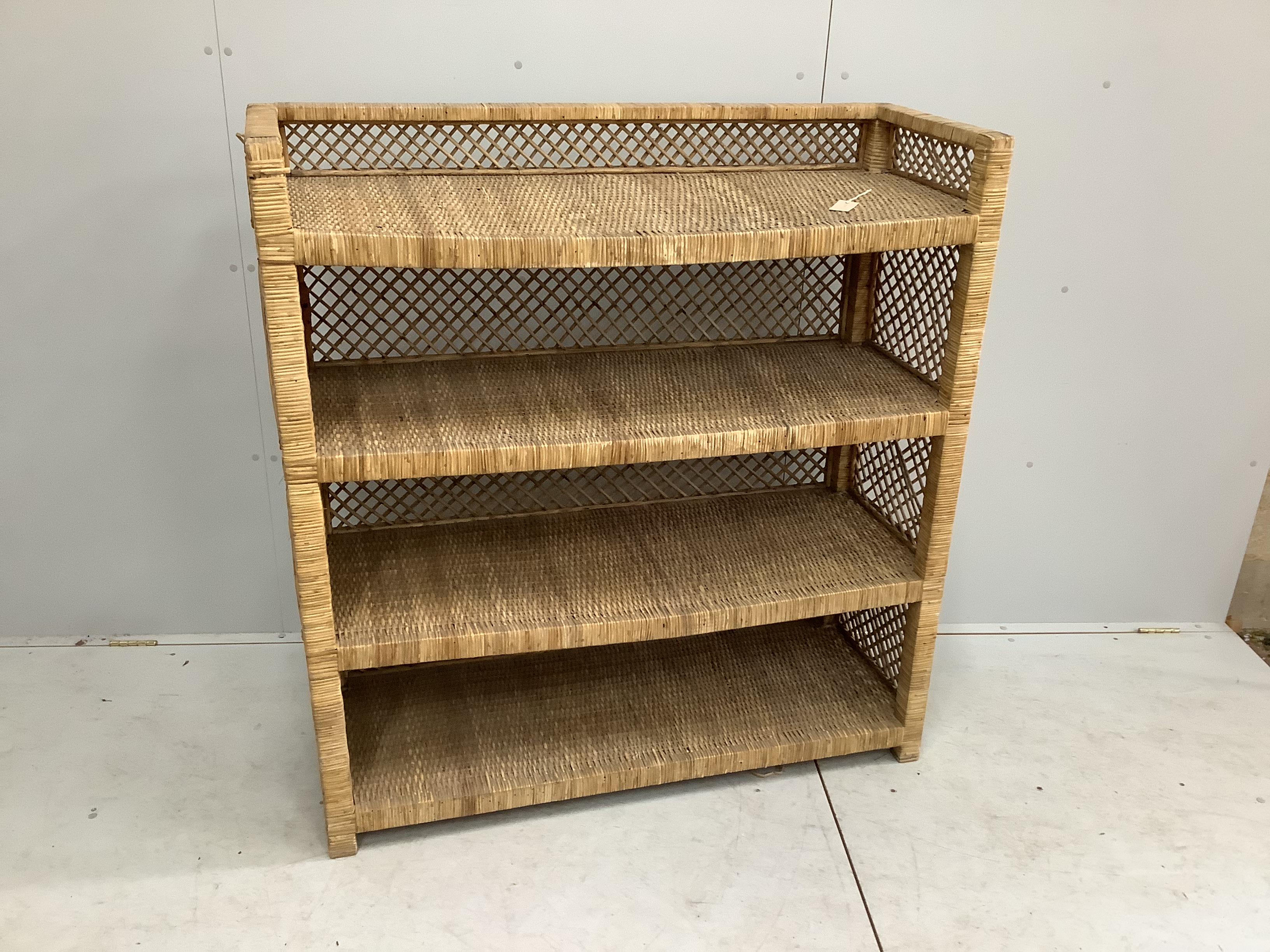 A wicker four tier shelving unit, width 121cm, depth 46cm, height 129cm